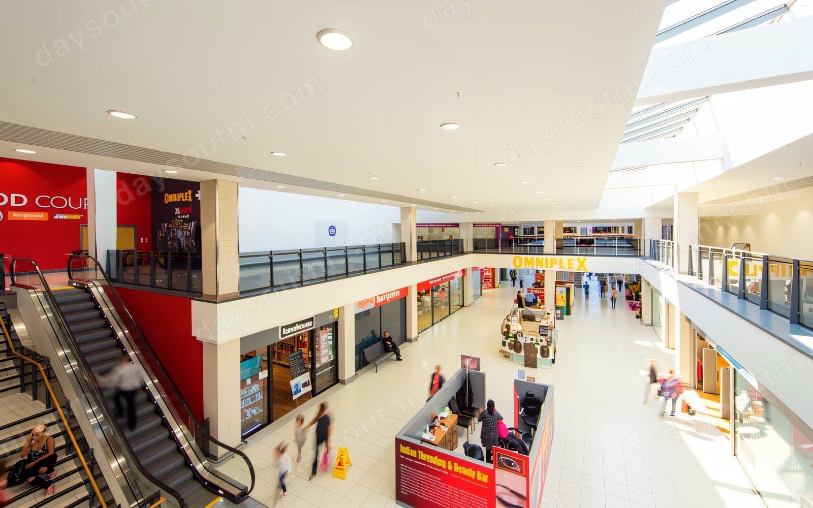 Inside the Kennedy Centre — the upper mall with the Omniplex cinema and food court above the escalators and shopfronts