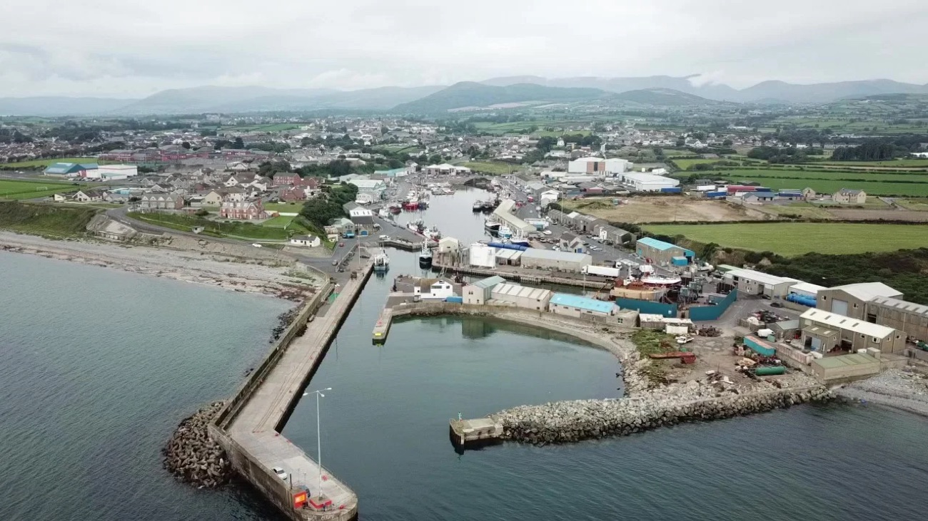 Aerial view of Kilkeel harbour, Northern Ireland's biggest fishing port, with the Mourne Mountains behind