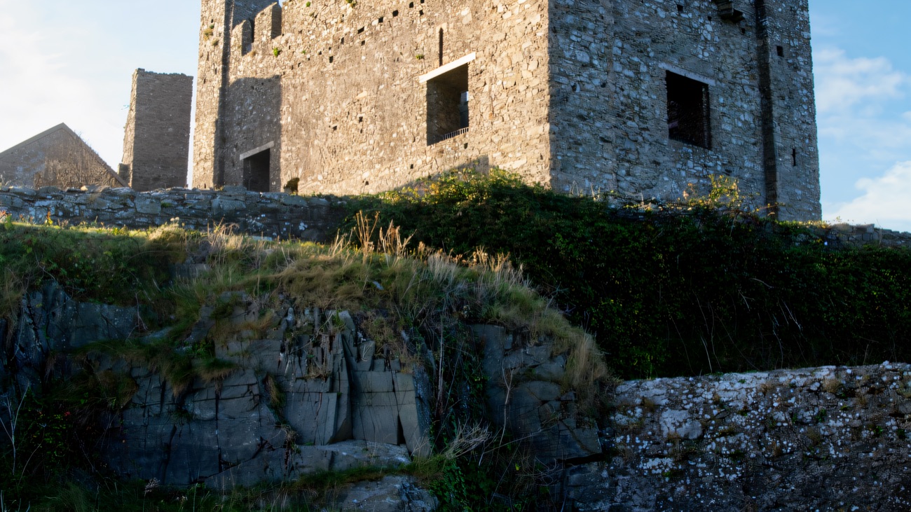 The castle ruin catching low golden light on its rock
