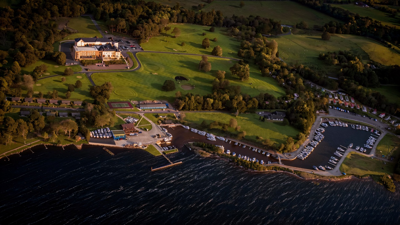 An aerial view of the marina on Lower Lough Erne with rows of moored boats and the manor grounds behind