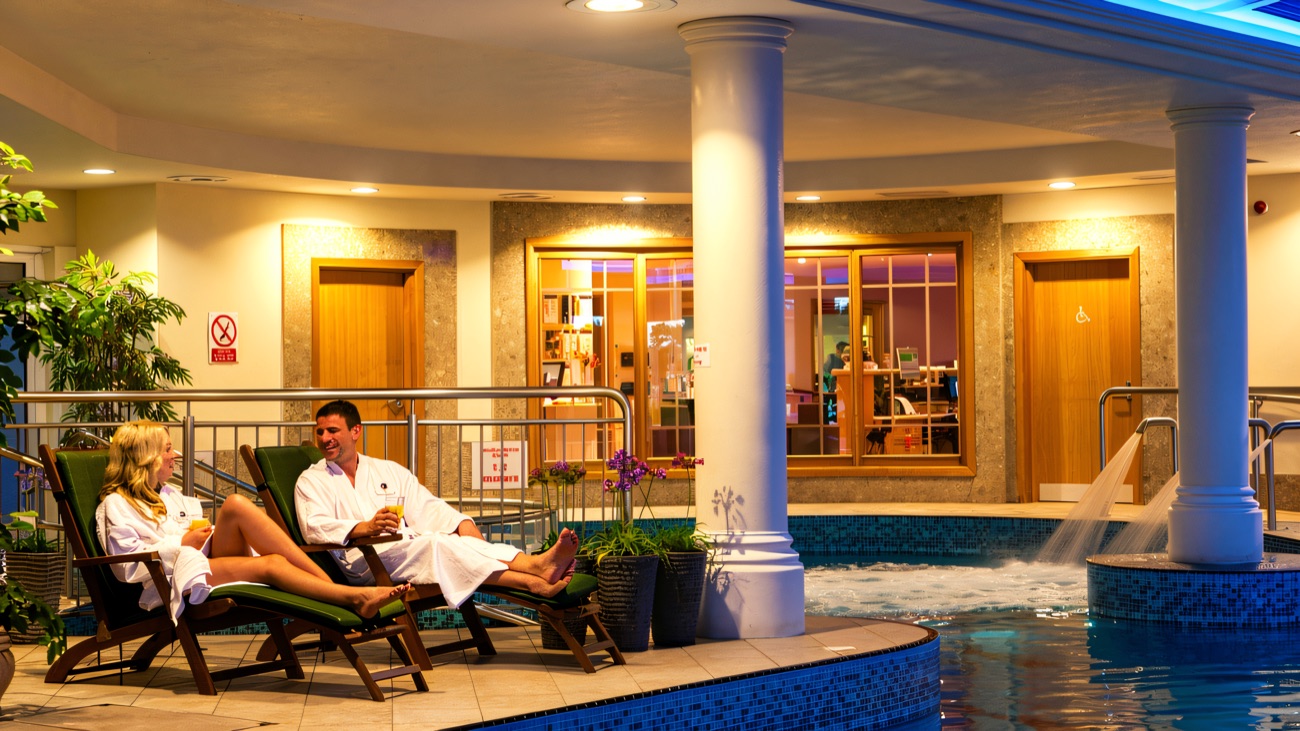 The indoor pool and hydrotherapy area, with a jacuzzi and water feature.