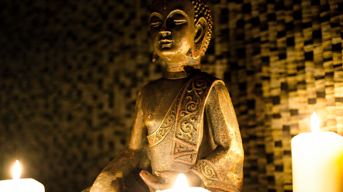 A gilded Buddha and candlelight set the calm tone at the spa.