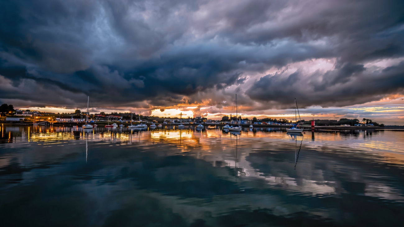 Moored yachts mirrored under a fiery Killyleagh sunset