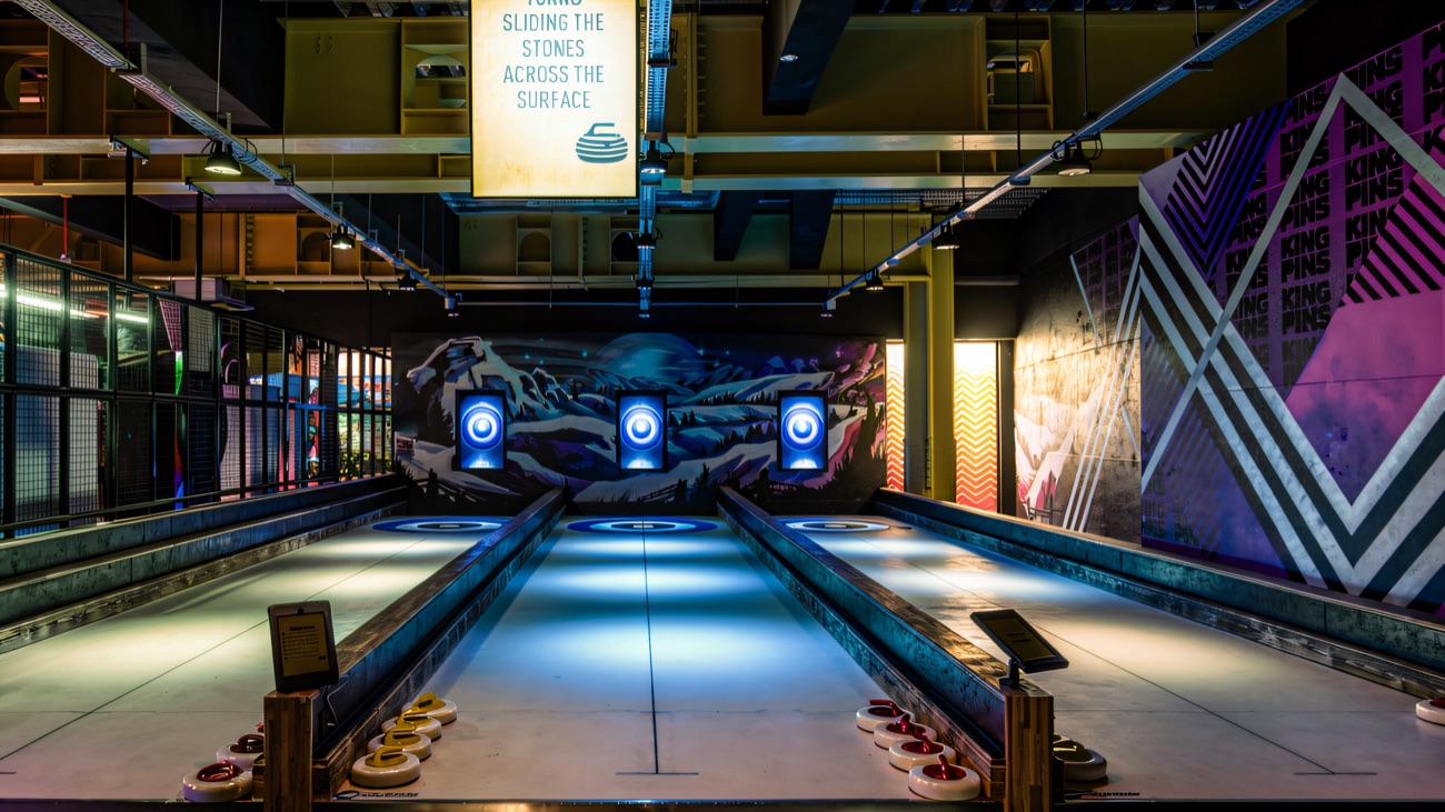 The blue-lit curling lanes, one of King Pins' many alternative games