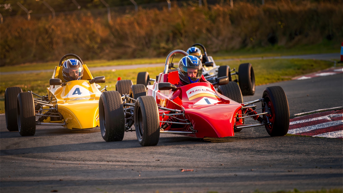 Open-wheel single-seaters racing wheel to wheel at Kirkistown