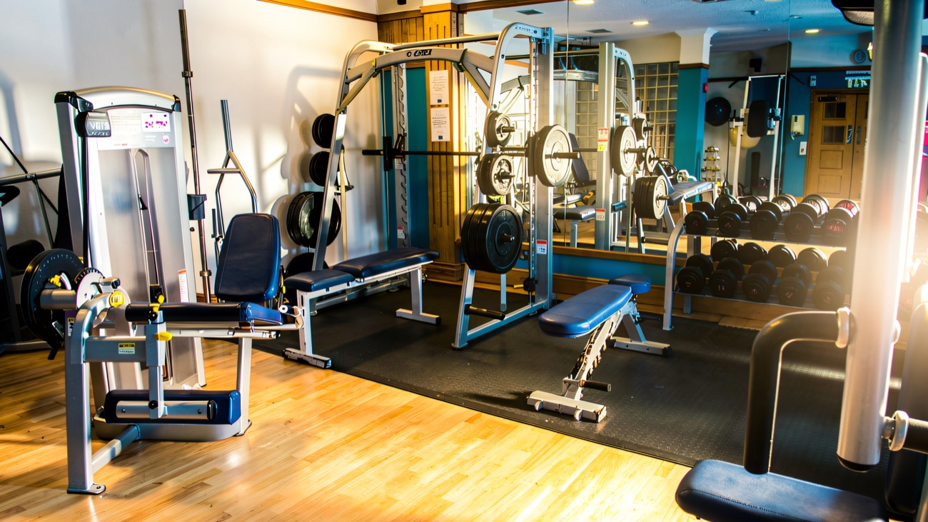 One of the two gyms, with free weights, benches and a wall of mirrors.