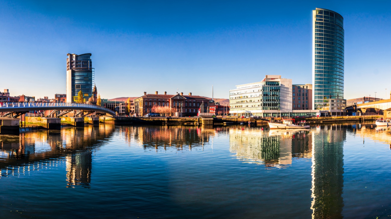 The River Lagan mirror-calm through the heart of Belfast, the view from the cruise.