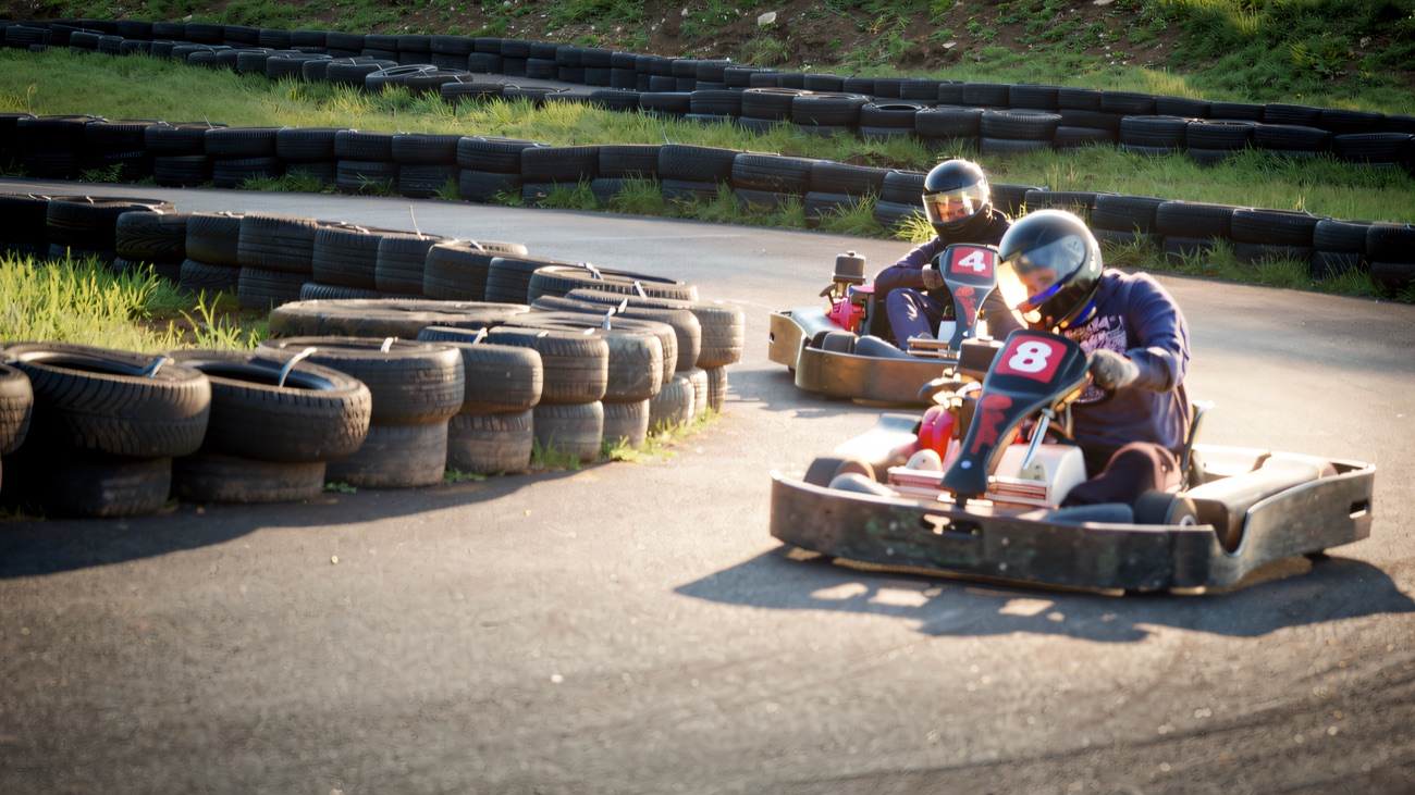 Two karts battling through the tyre-lined corner