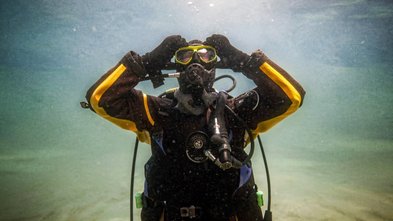 A diver underwater in the green Irish Sea, signalling OK to the camera.