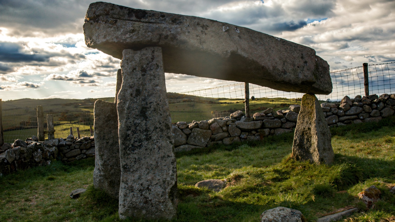 A side profile showing the tilted capstone balanced on slim uprights.