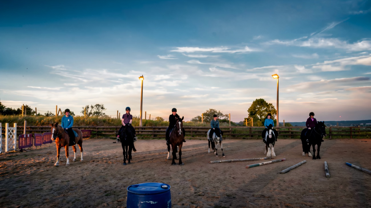 A group lesson lined up across the outdoor arena