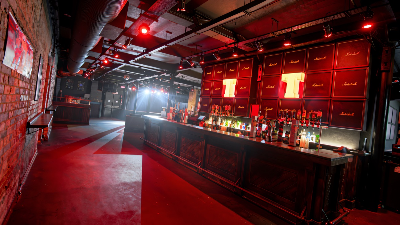 The main room lit red, with a wall of amplifiers behind the stage