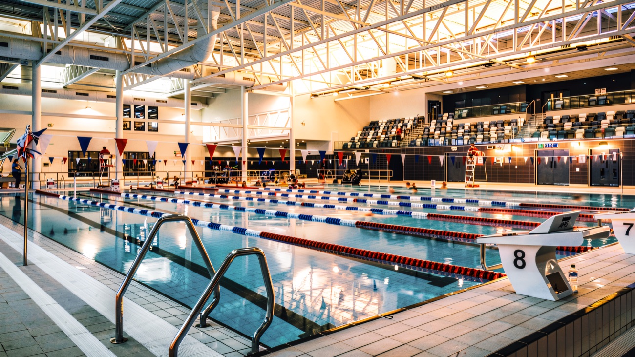 The full-size competition pool under a high curved roof