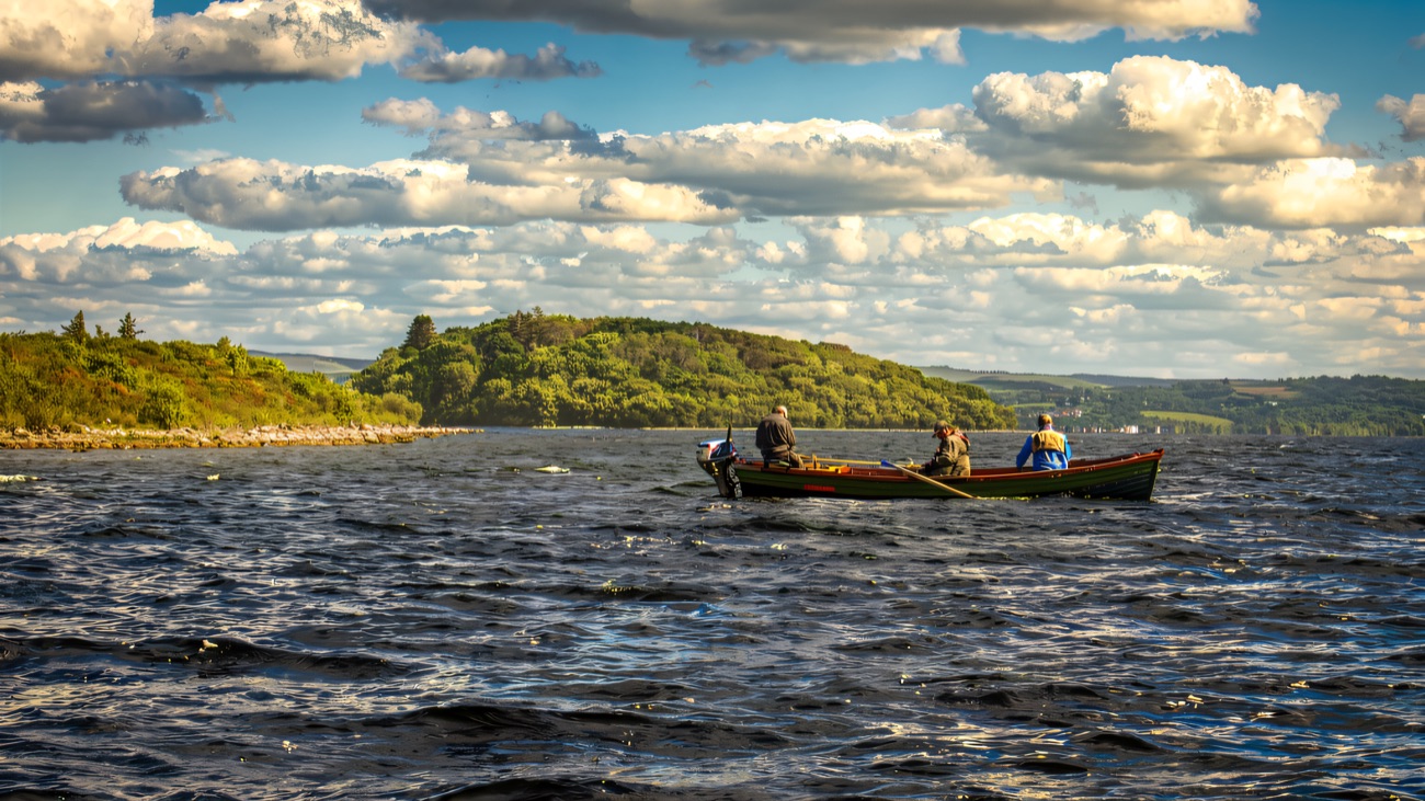 A traditional wooden lough boat out on the open water