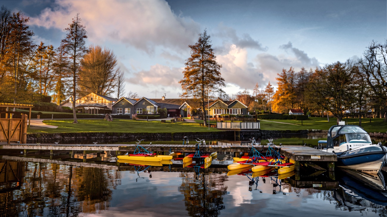 Water bikes and pedalos lined up at the jetty, ready for a lap of the lake