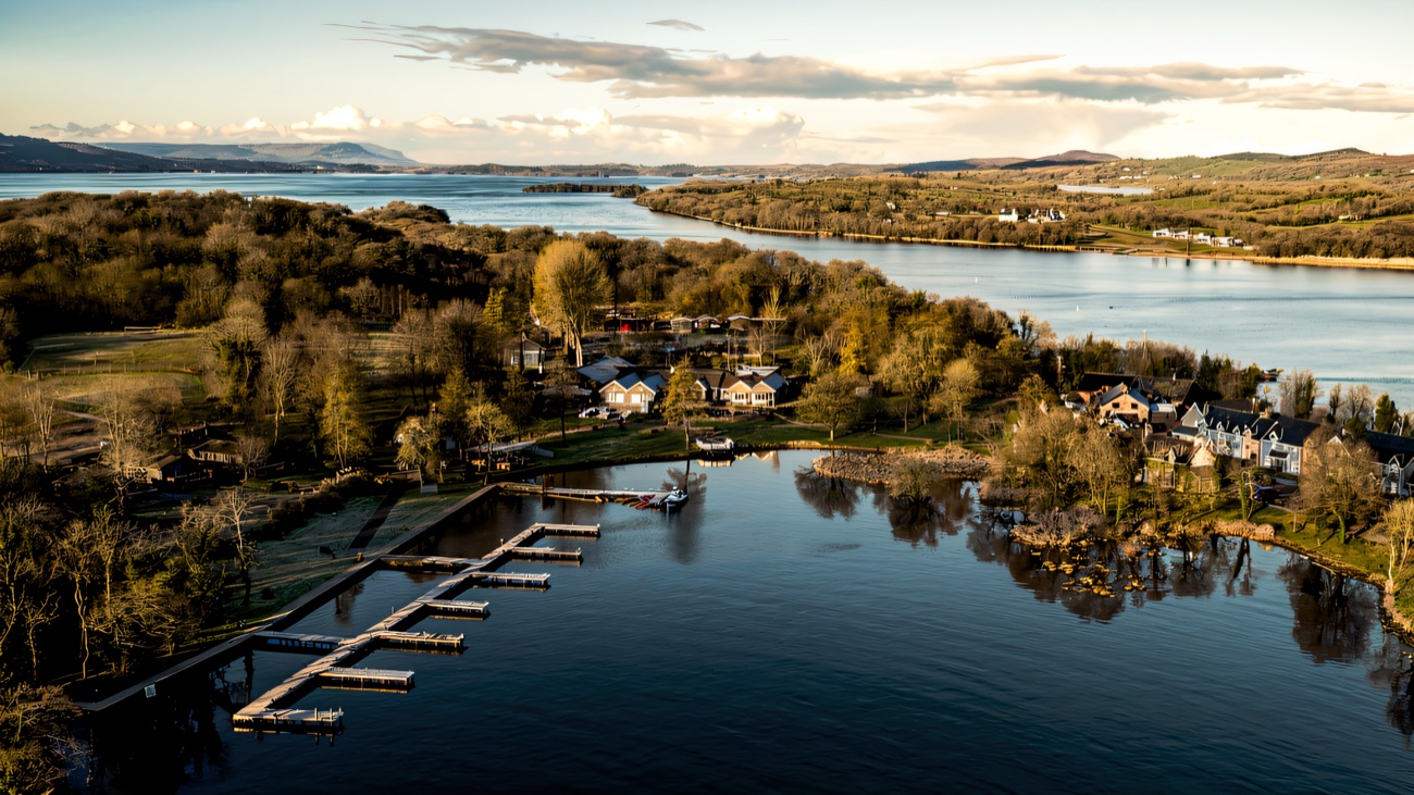 The marina and lodges tucked into the shoreline, lough shimmering all around