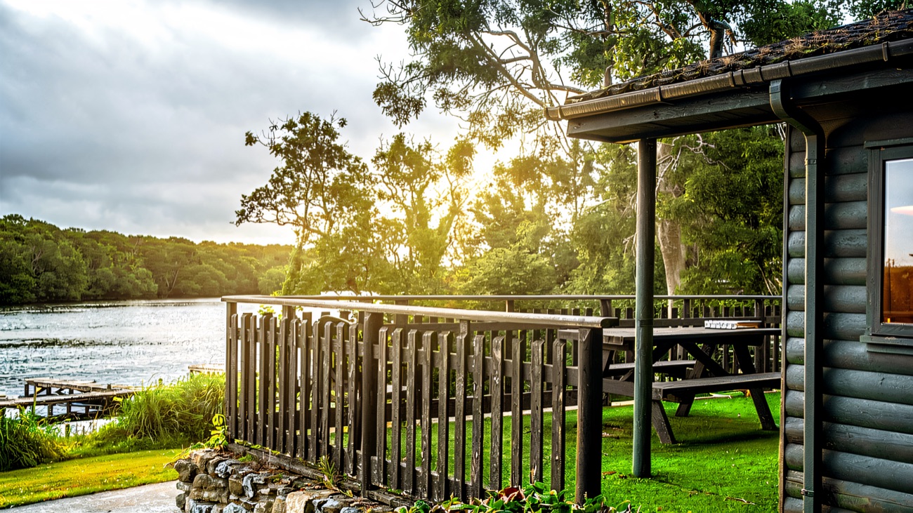 A lodge deck with the water lapping just beyond the rail