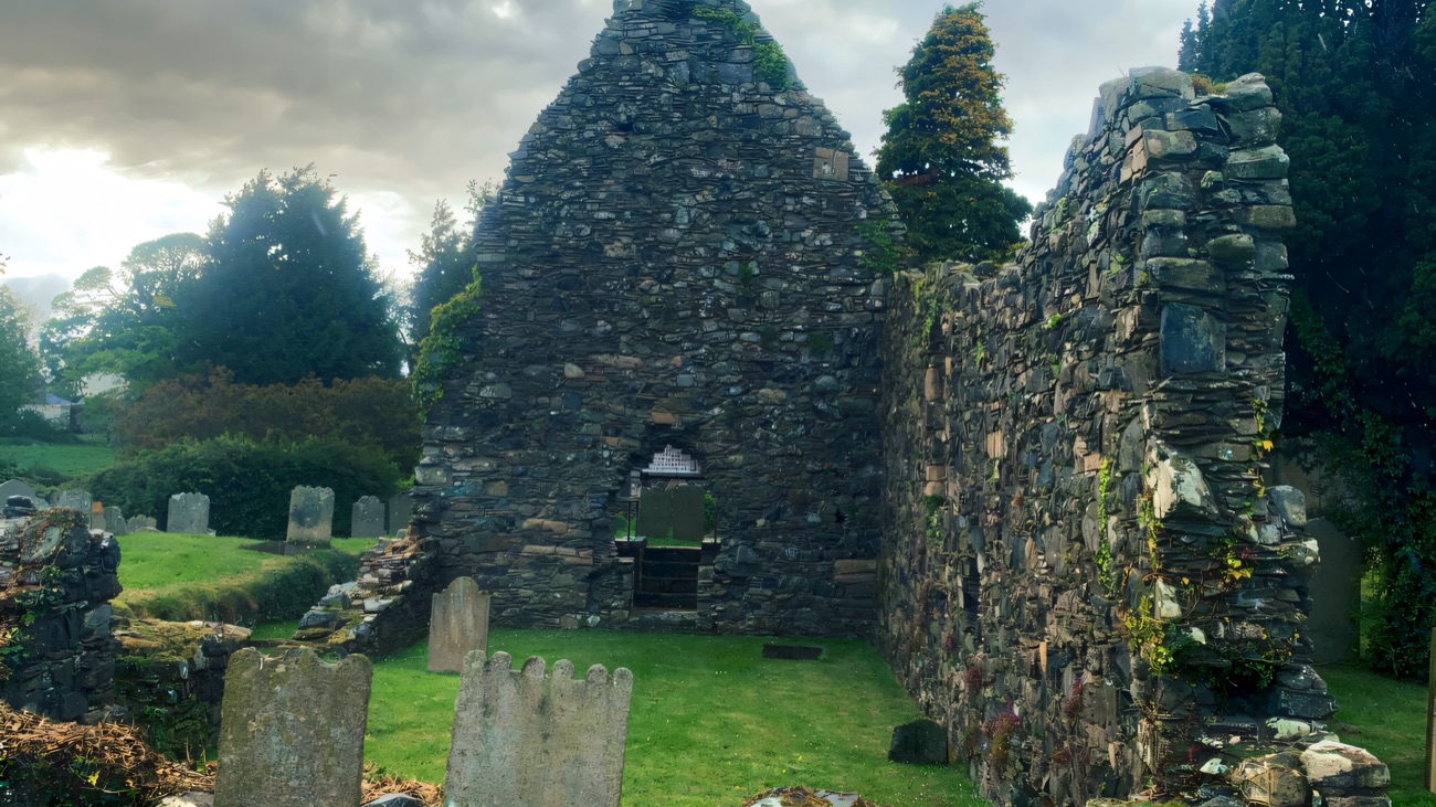 The gable end from a closer angle, thick walls still standing.