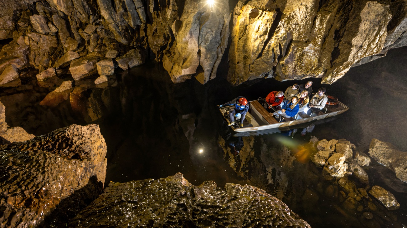 Looking down on the little boat crossing the dark underground river