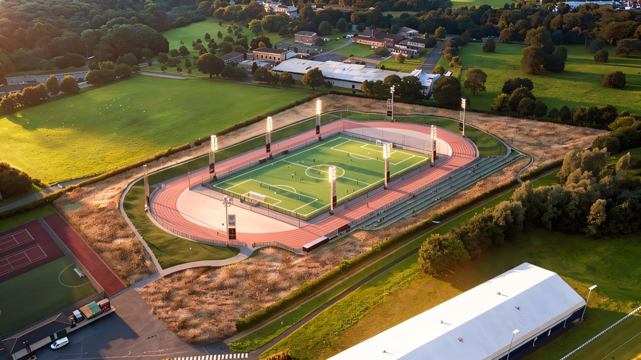 Looking down on the running track, floodlit pitch and the domed indoor hall