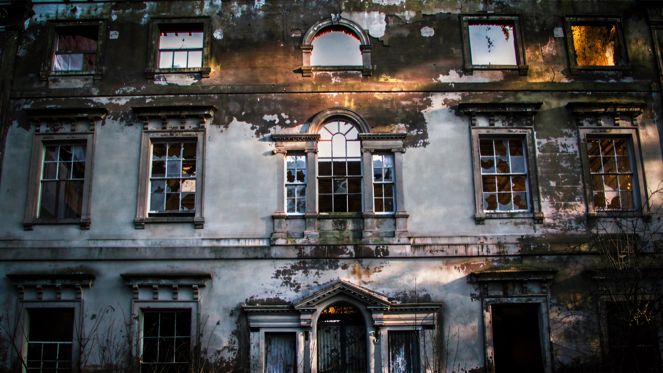The front of the ruined Mount Panther House, its grand windows empty and the plasterwork peeling