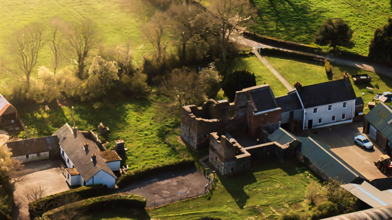 An aerial view of the castle ruin among the farm buildings near the Lough Neagh shore.