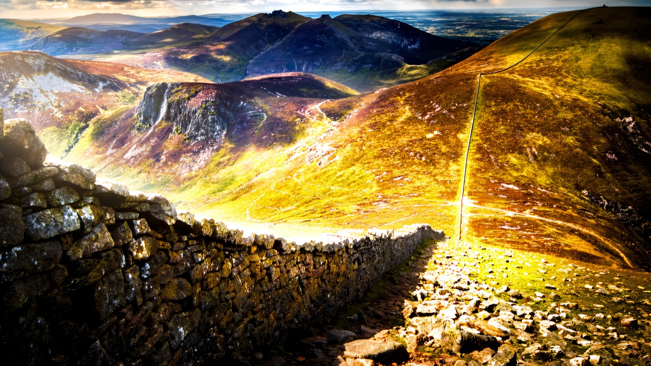 The Mourne Wall dropping down the hillside beside the path