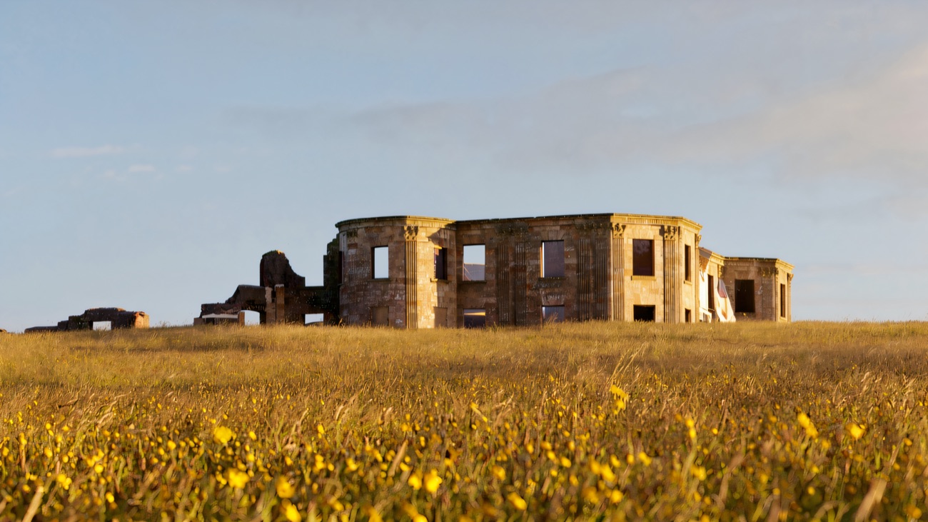 The roofless ruin of Downhill House rising above a meadow of buttercups under a blue sky