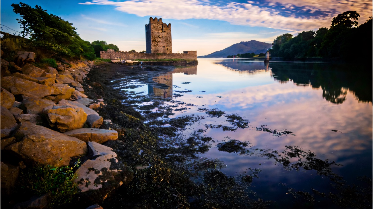 Narrow Water Keep mirrored in the still river at dawn