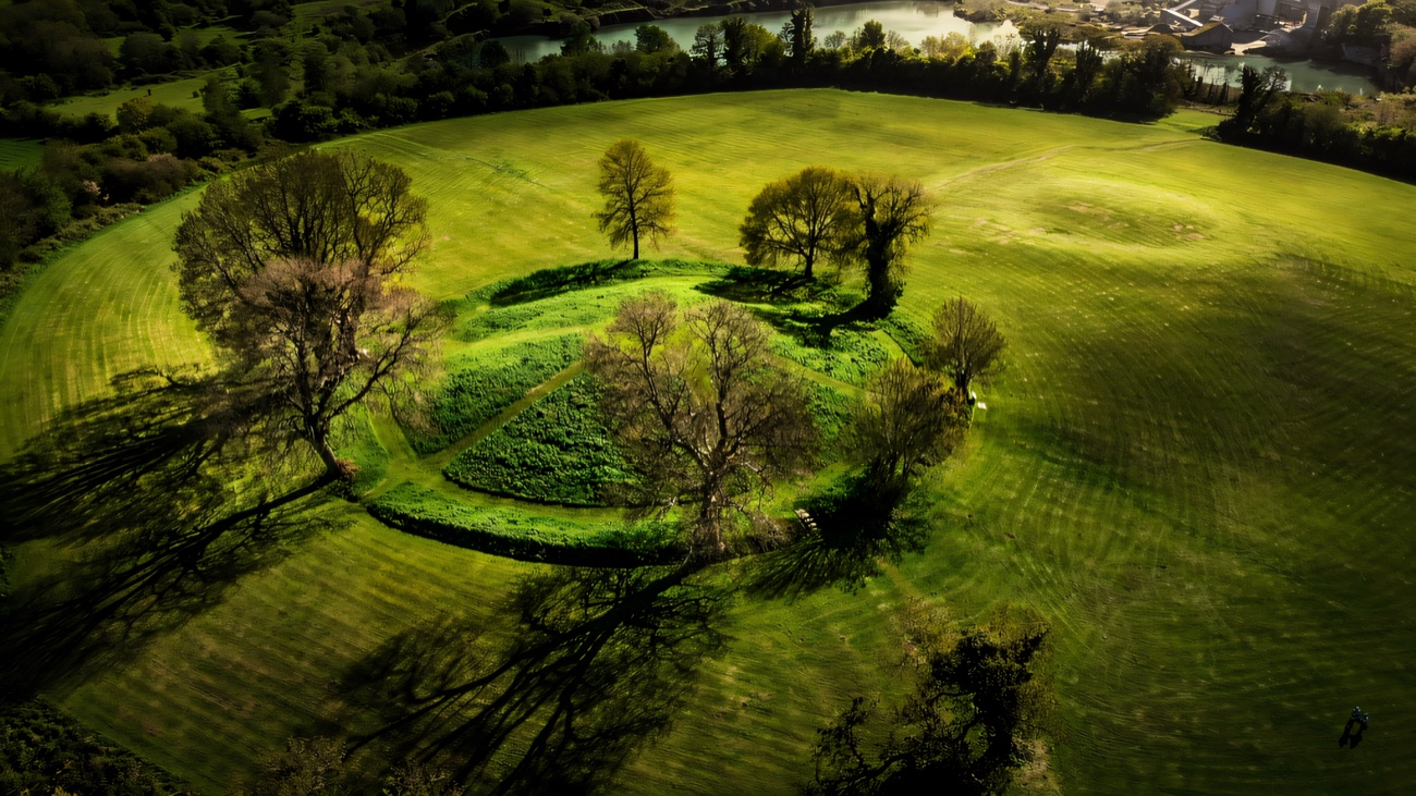 Closer aerial of the central mound and trees within the Navan Fort earthwork enclosure