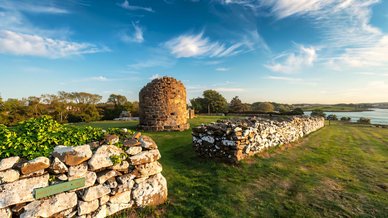 The rebuilt round tower base with Strangford Lough just beyond.