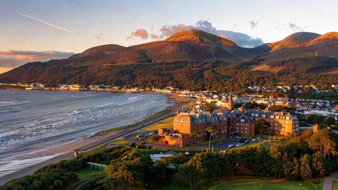 Golden light over the seafront with Slieve Donard behind