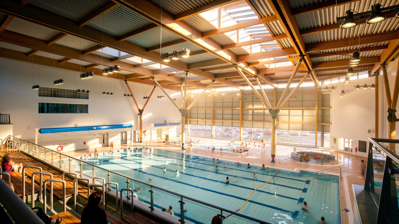 The main pool under its timber roof, seen from the viewing balcony