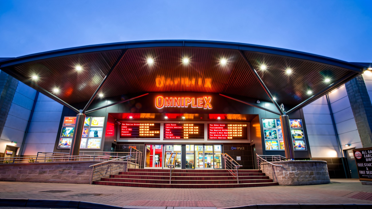 The curved canopy entrance glowing at dusk
