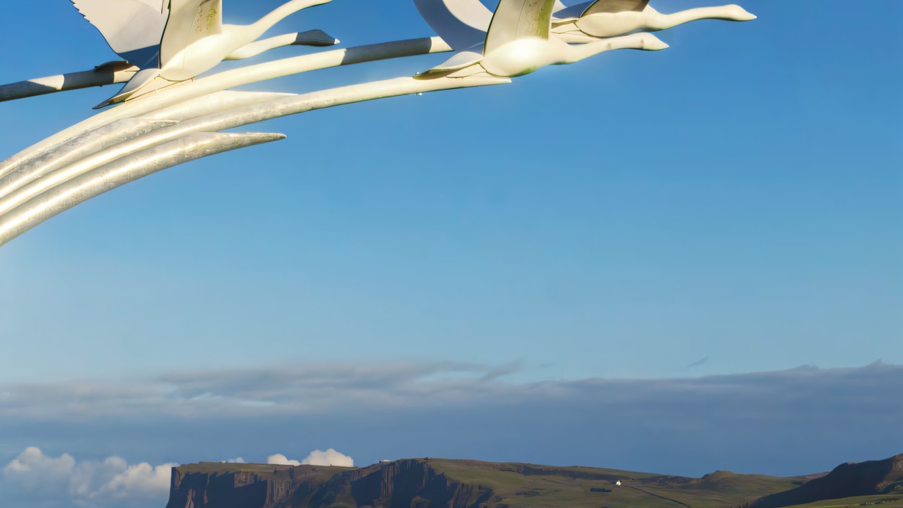 The Children of Lir swan sculpture on the green, looking out over blue water towards Fair Head