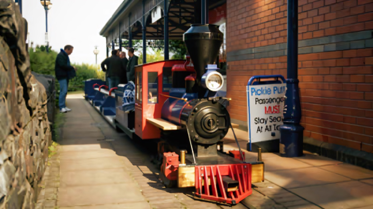 The little red Pickie Puffer miniature train waiting at its station platform