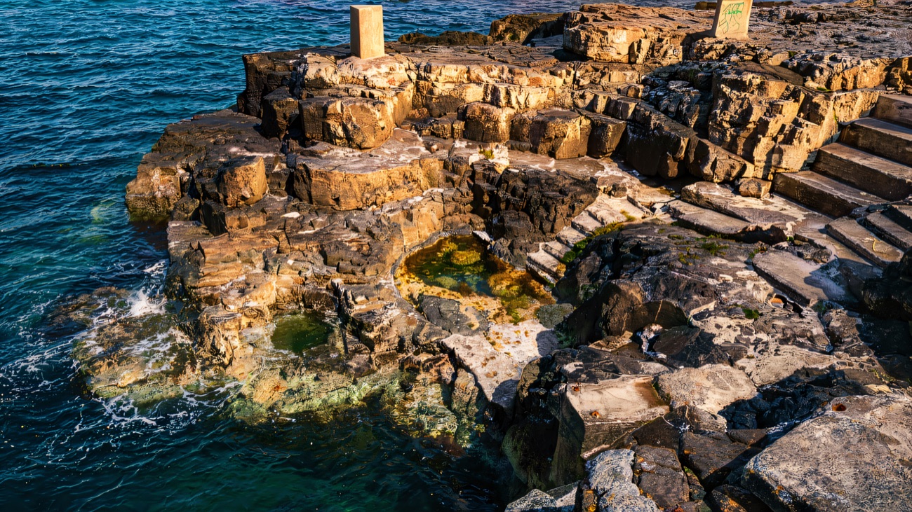 The Blue Pool, a natural rock basin of clear seawater set into the foreshore.