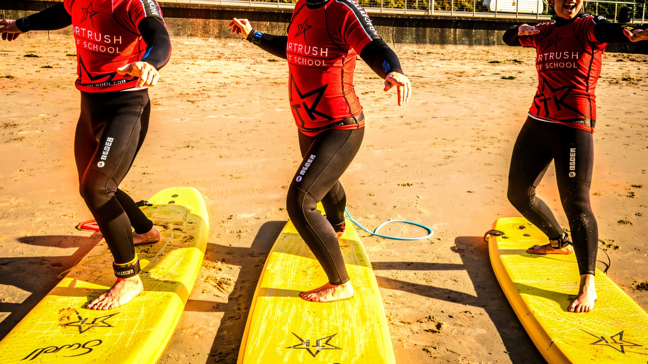 Finding your feet on the board, grins all round in the shallows