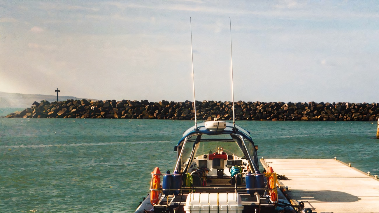 Tied up at the pontoon, looking out past the harbour wall