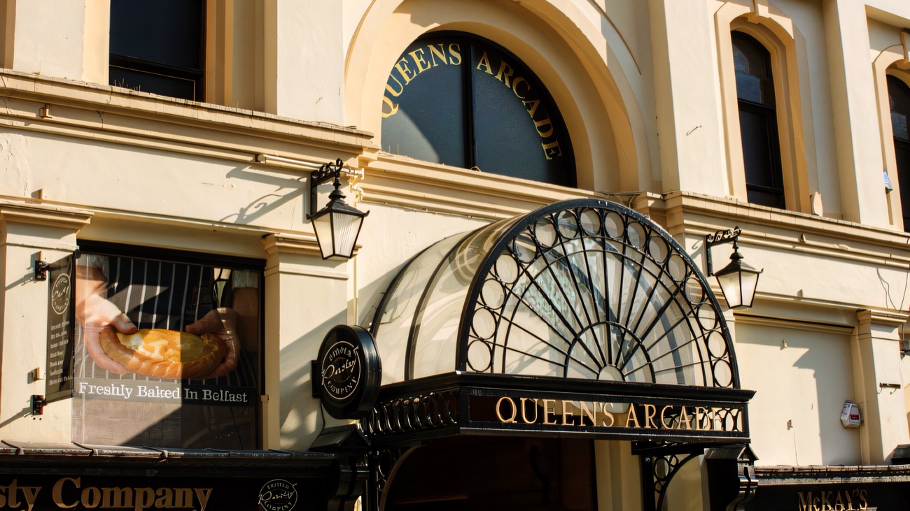 The Fountain Street entrance to Queen's Arcade with its glazed fan canopy and hanging lamps