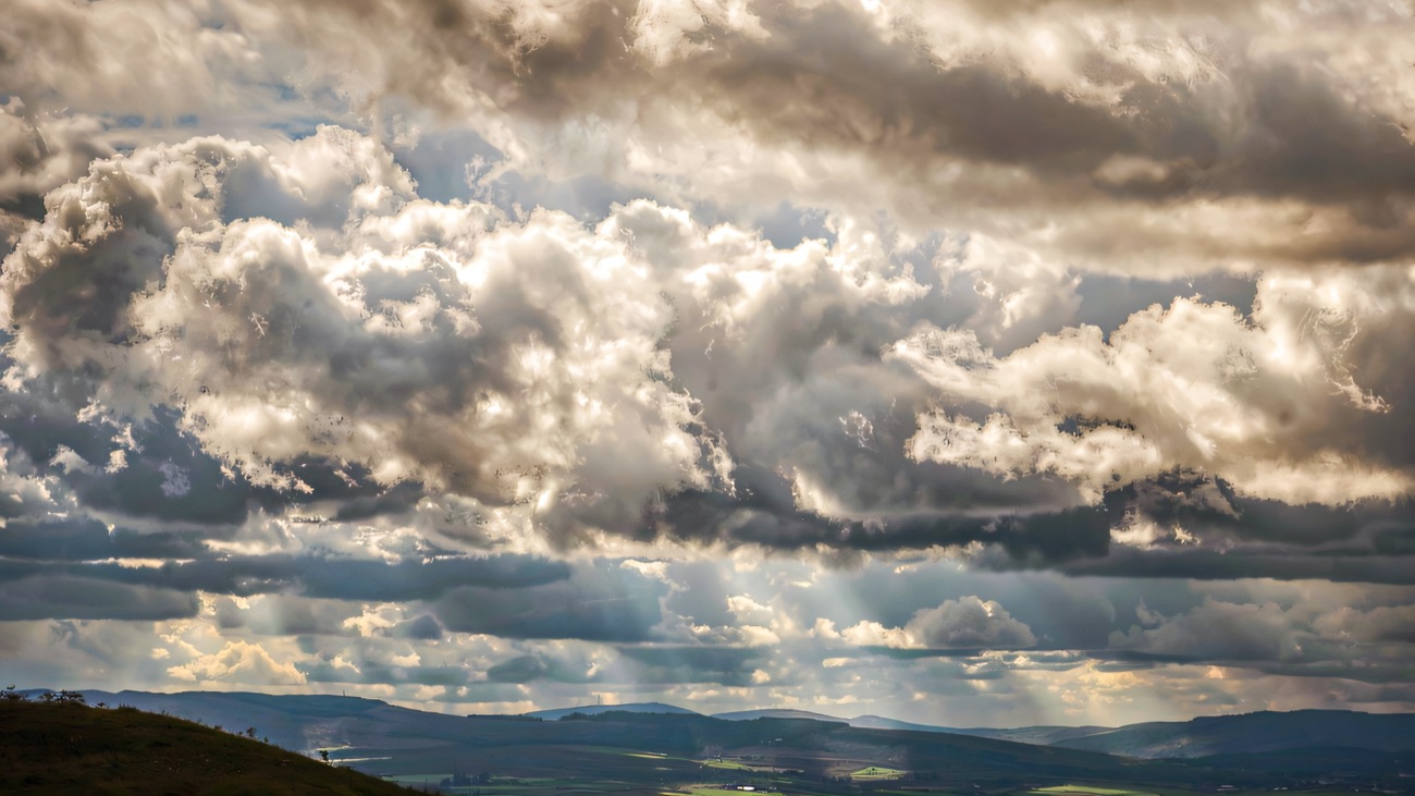 A glider riding the air above the Binevenagh escarpment, with the patchwork fields of the Roe valley far below