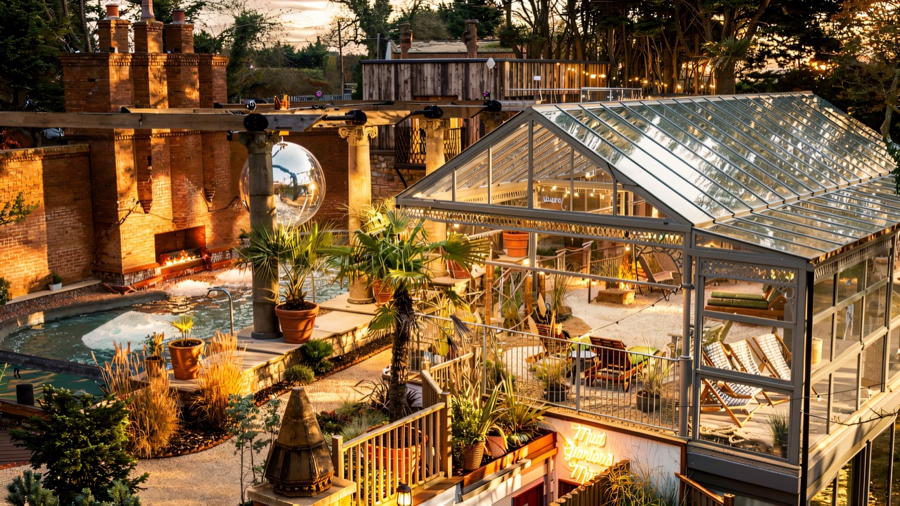 The outdoor spa garden with palms, the Palm House glasshouse and the Roman bath.