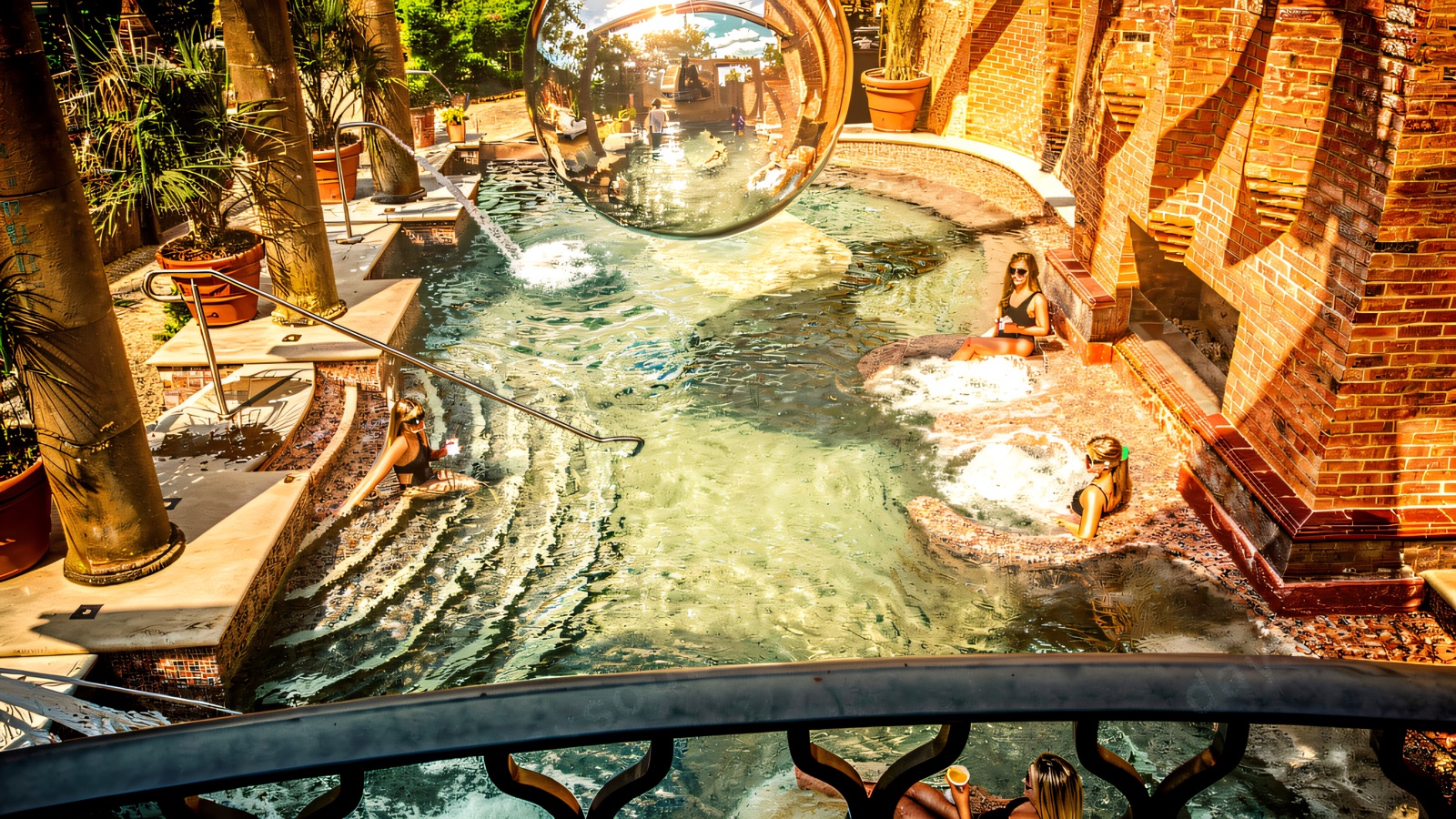 The disco-ball Roman bath at The Rabbit spa, steaming beside old brick walls.