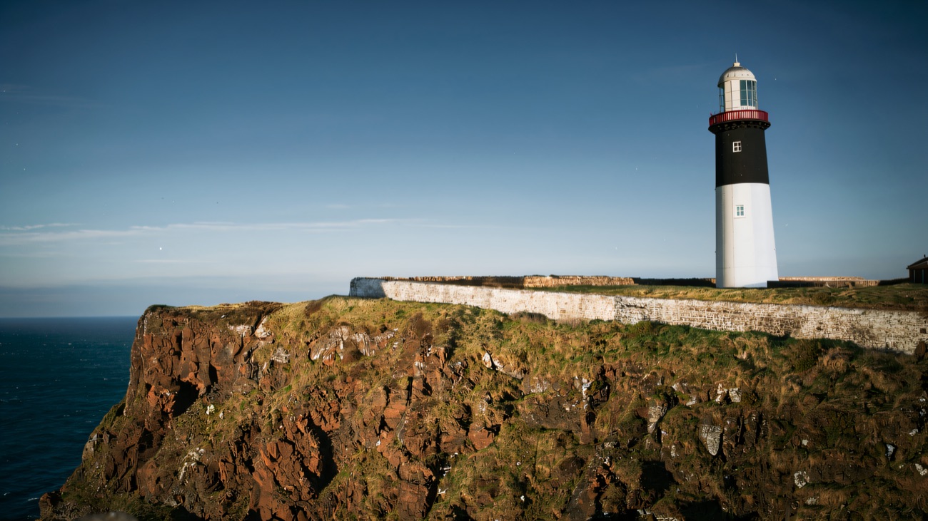 Rathlin's black-and-white East Lighthouse on the cliff edge