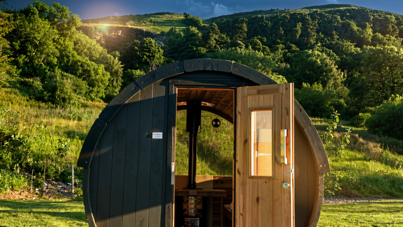 The barrel sauna outside with Cavehill rising behind
