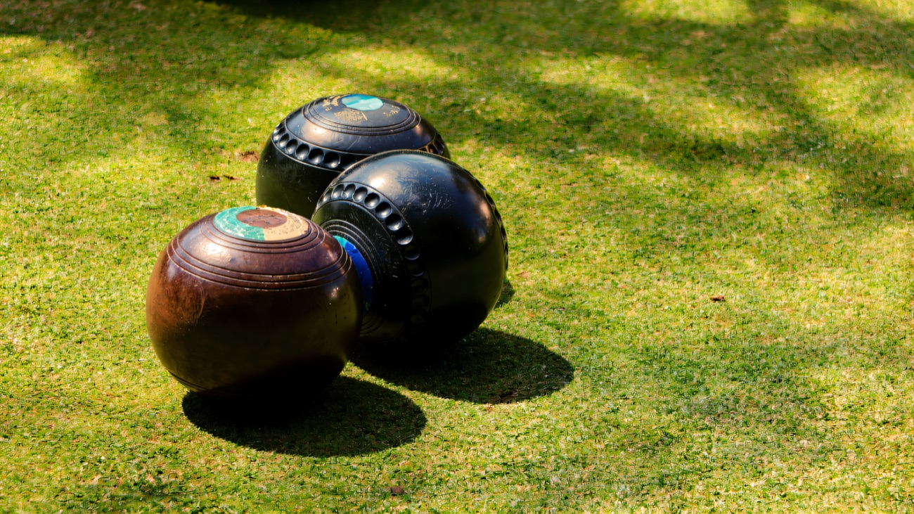 Bowls resting on the sunlit green