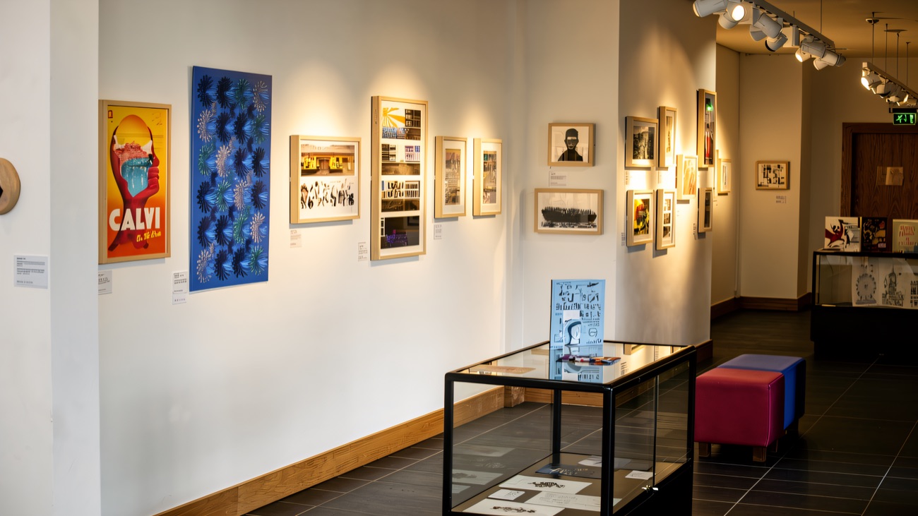 The bright exhibition gallery with framed prints and display cases