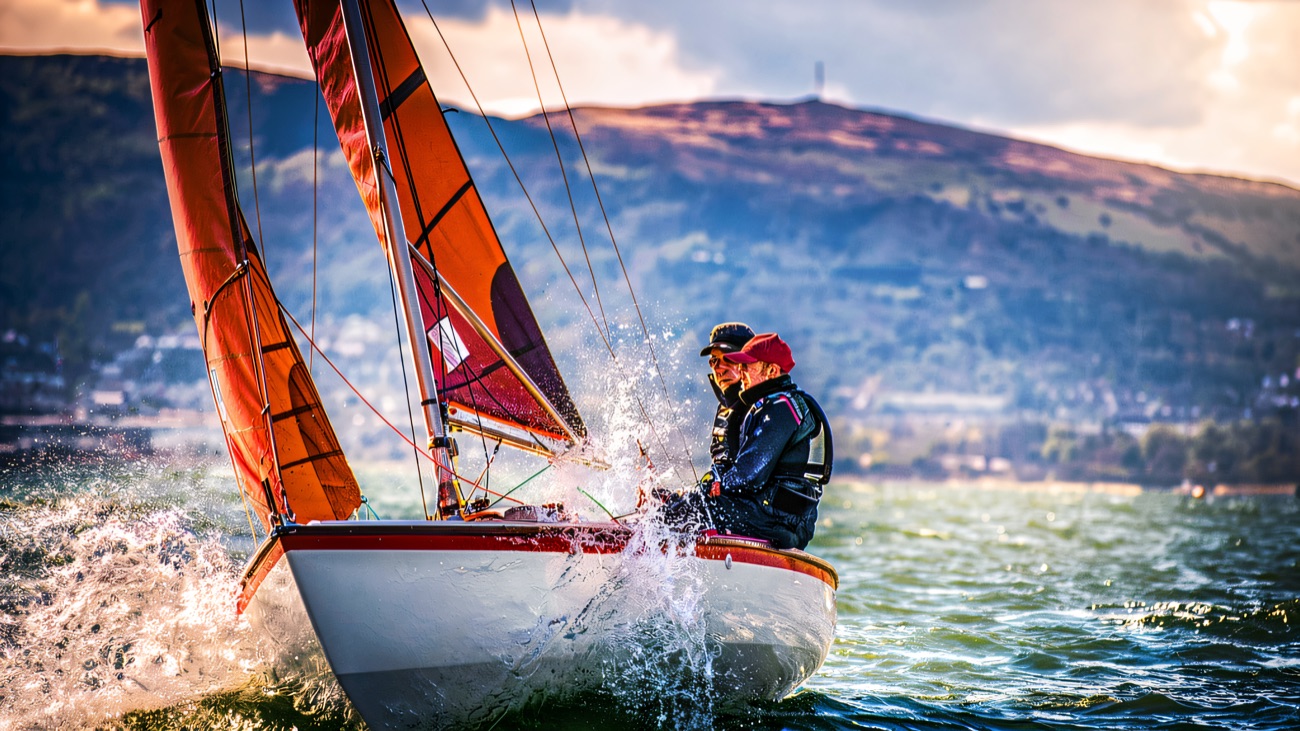 Red sails and flying spray, a dinghy powering across the lough