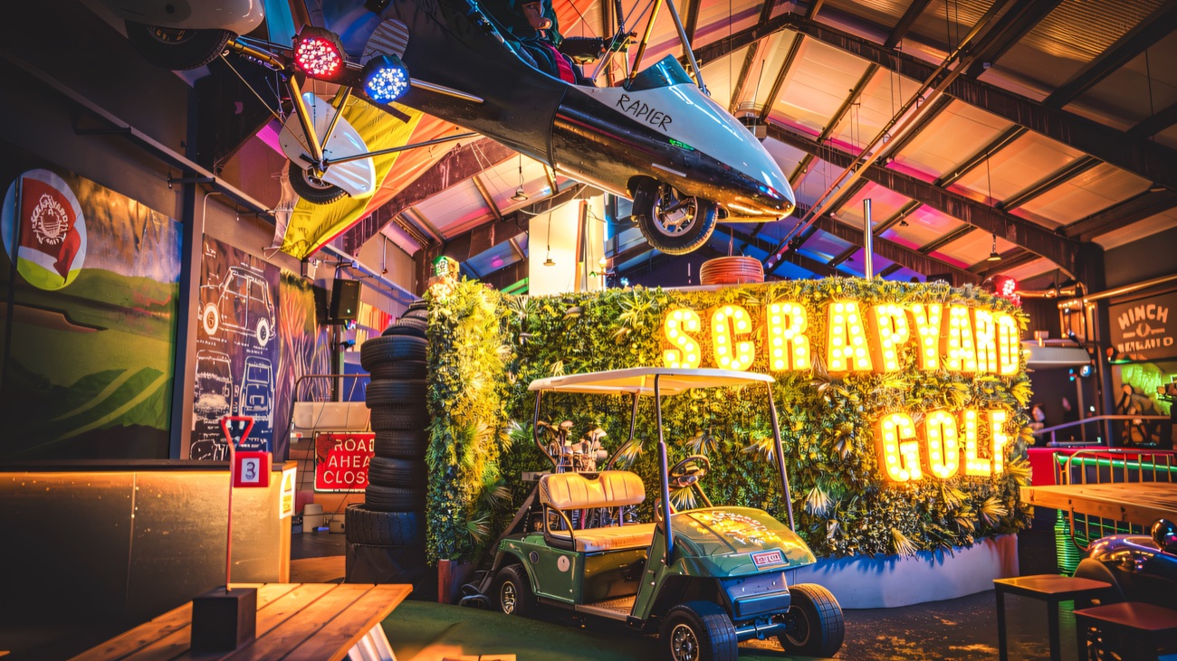 The neon Scrapyard Golf sign, buggy and hanging plane at Glengormley