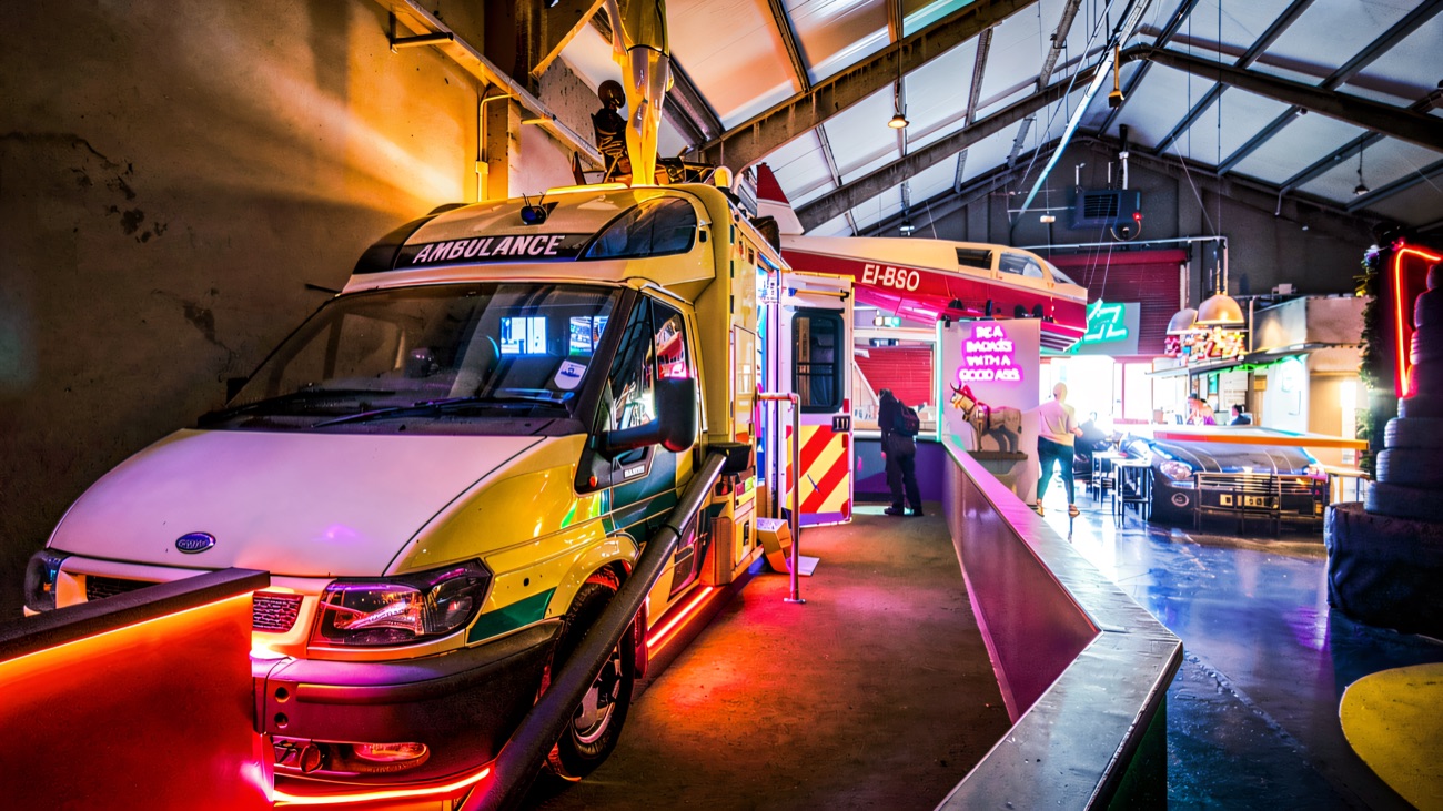 The ambulance feature lit up along the neon course